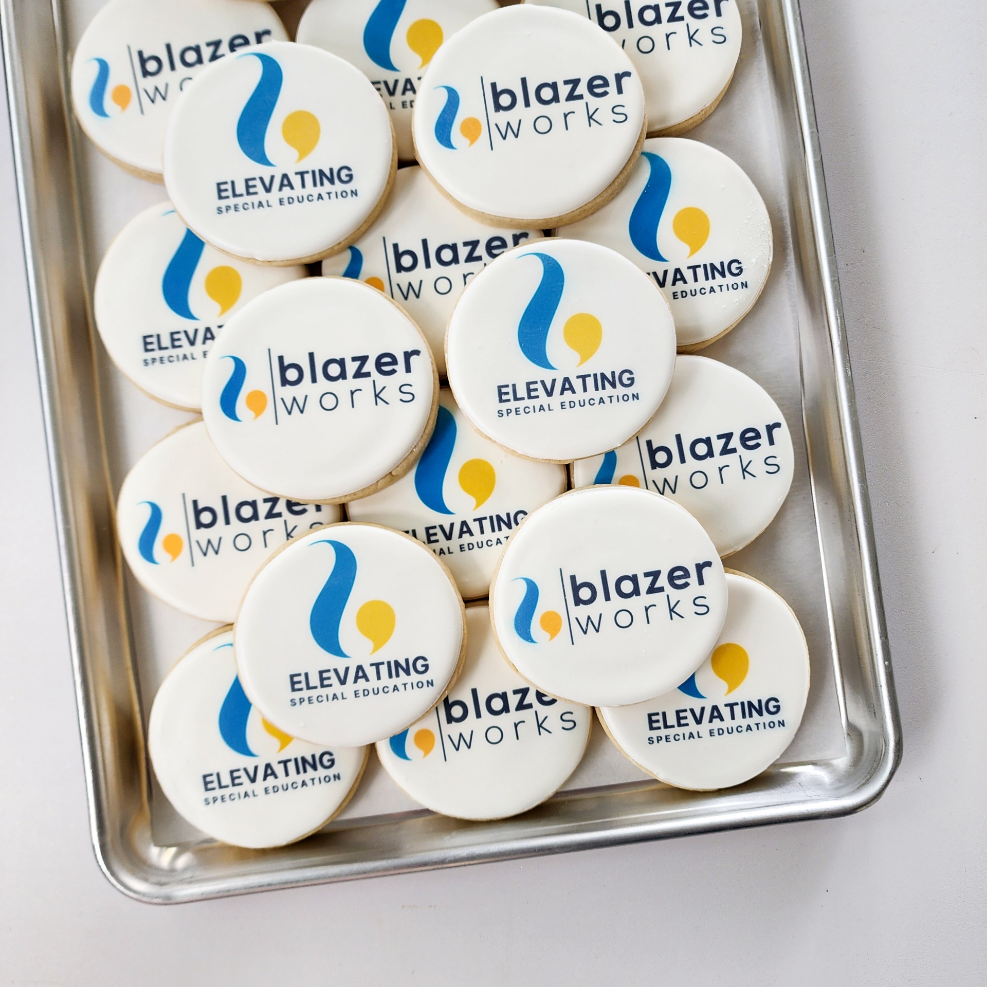 BlazerWorks branded logo cookies on a sheet tray