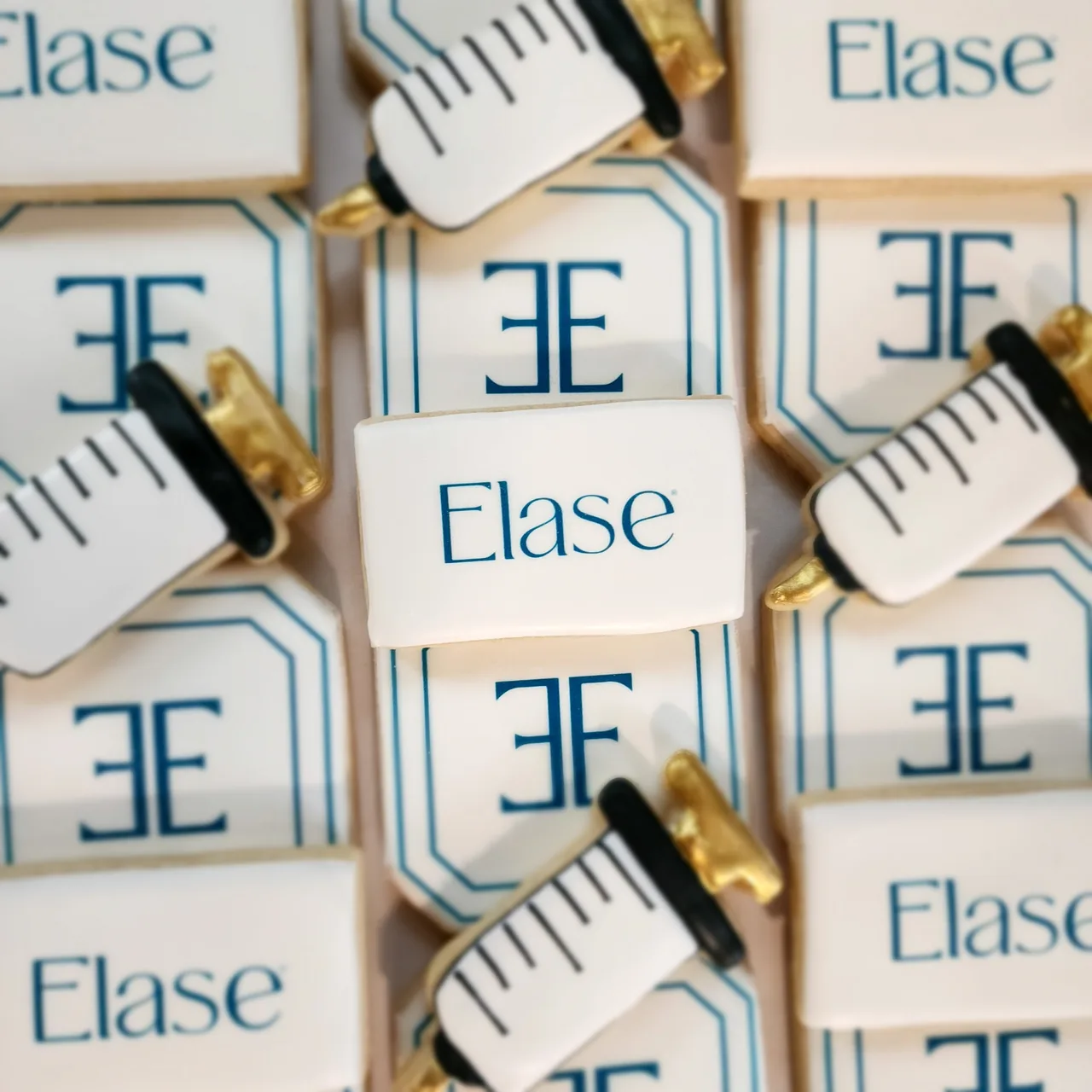 Elase branded logo cookies with syringe accents