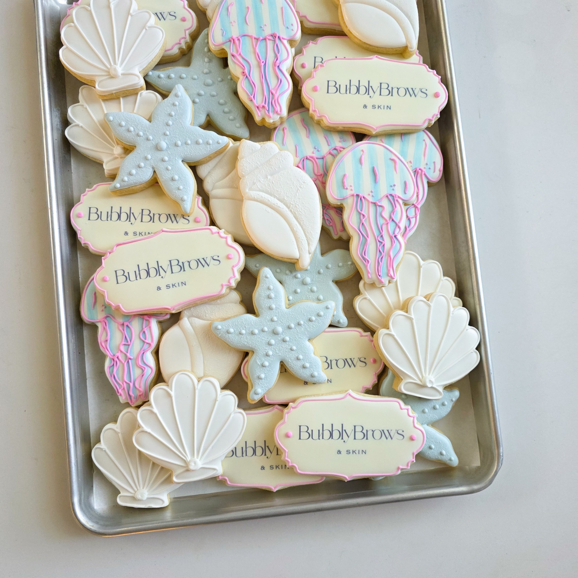 BubblyBrows & Skin themed launch cookies with seashells and jellyfish