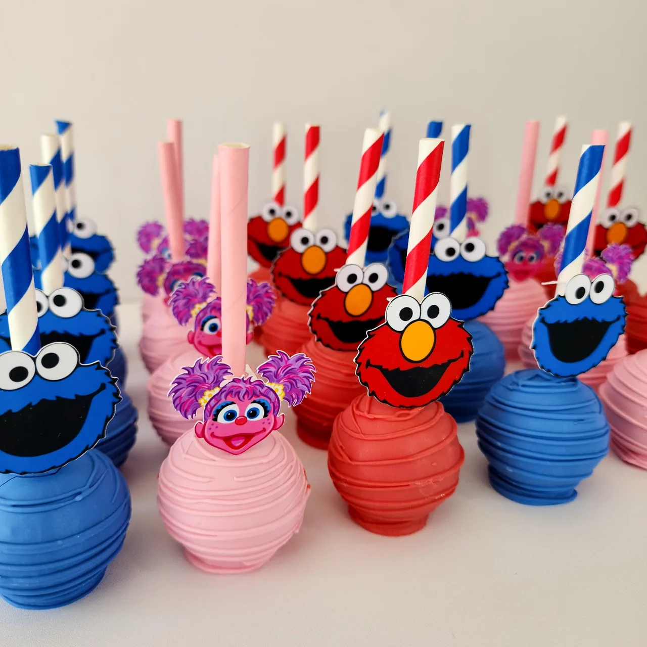 Colorful character-themed cake pops by Ellie Mae's Bakery