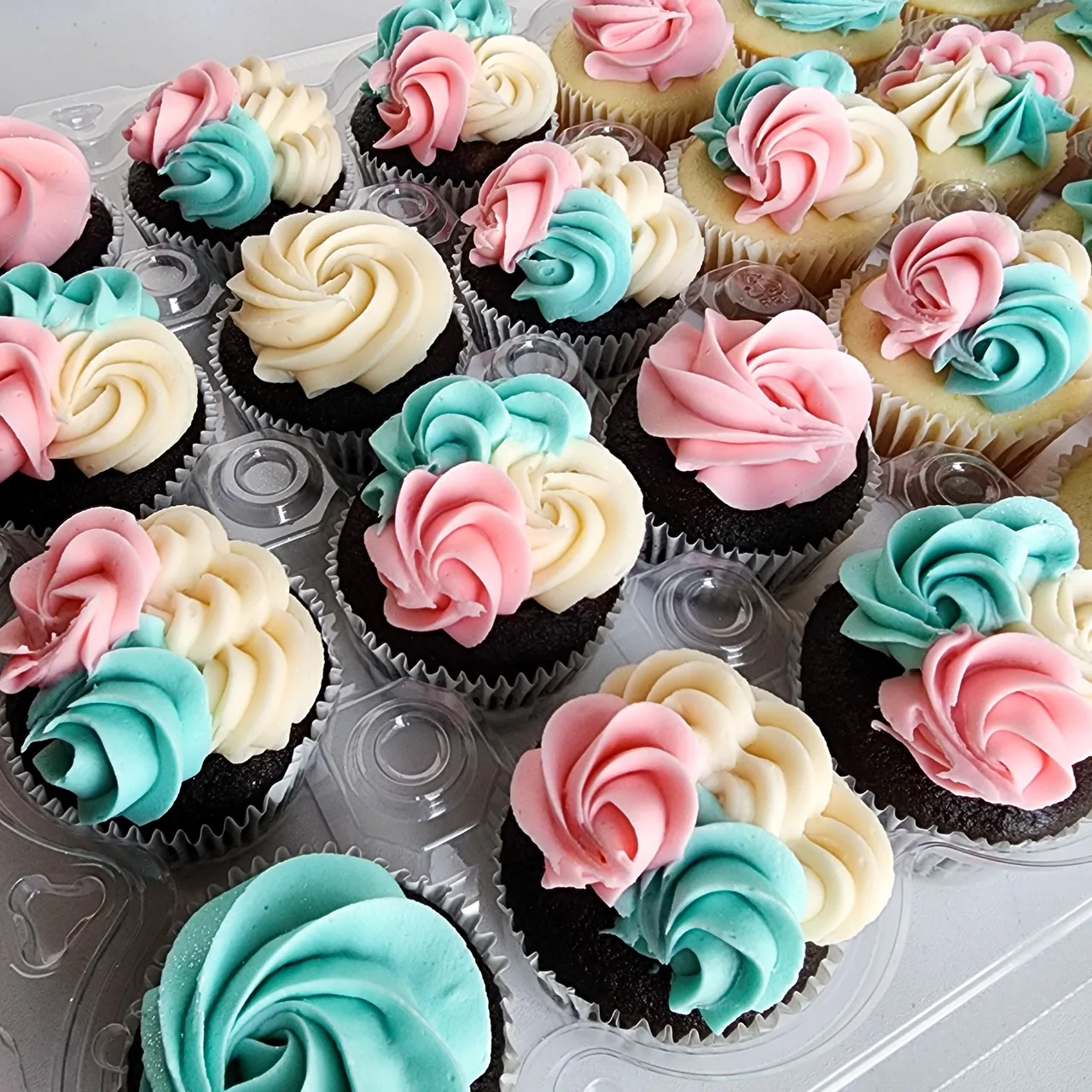Pastel pink, teal, and cream rosette cupcakes