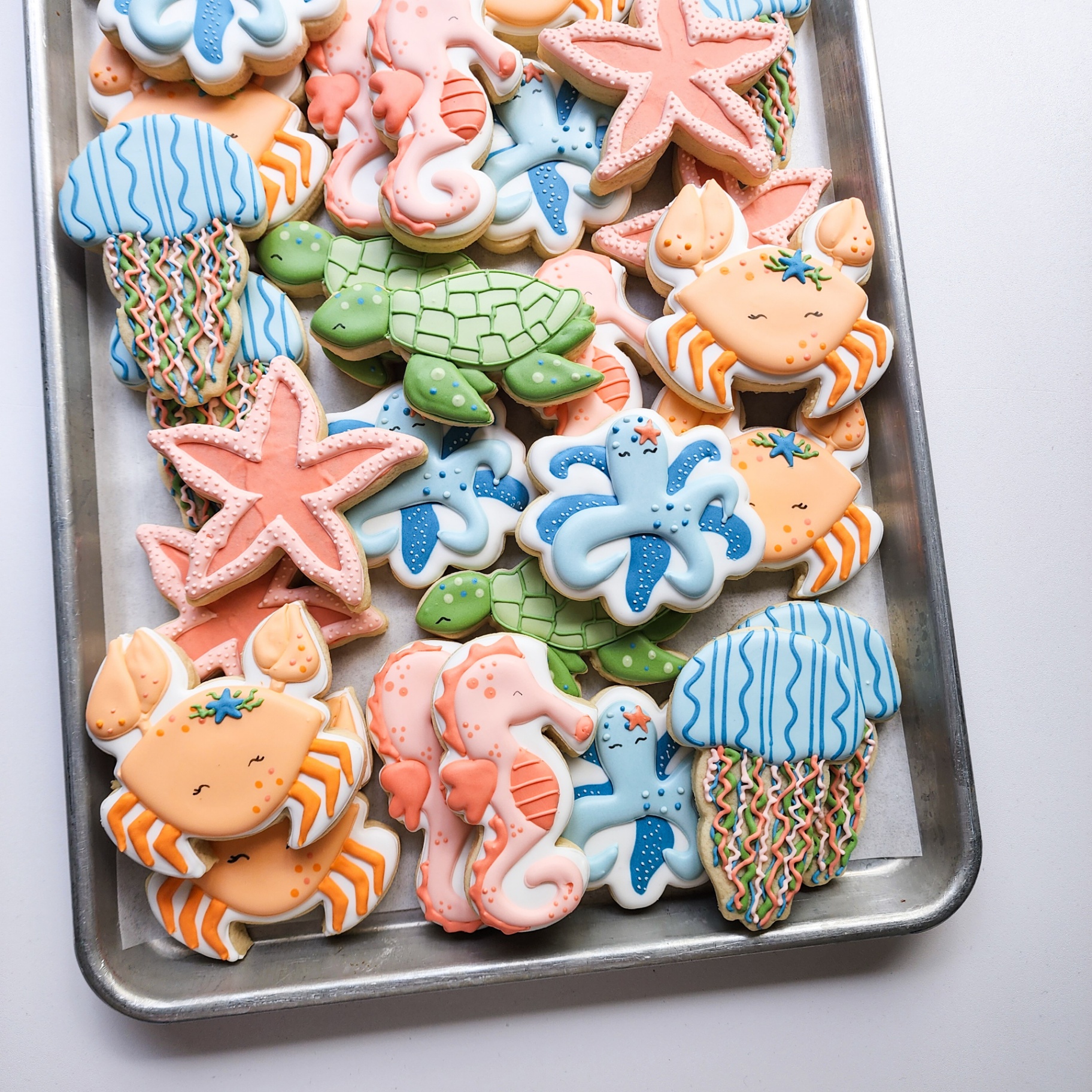 Ocean-themed decorated sugar cookies including starfish, seahorses, and sea turtles